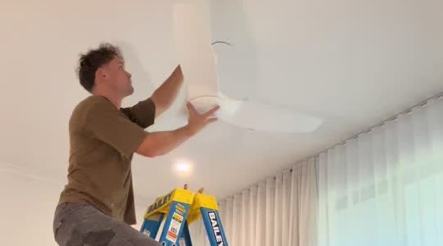 Marcus installing a ceiling fan in an Adelaide bedroom
