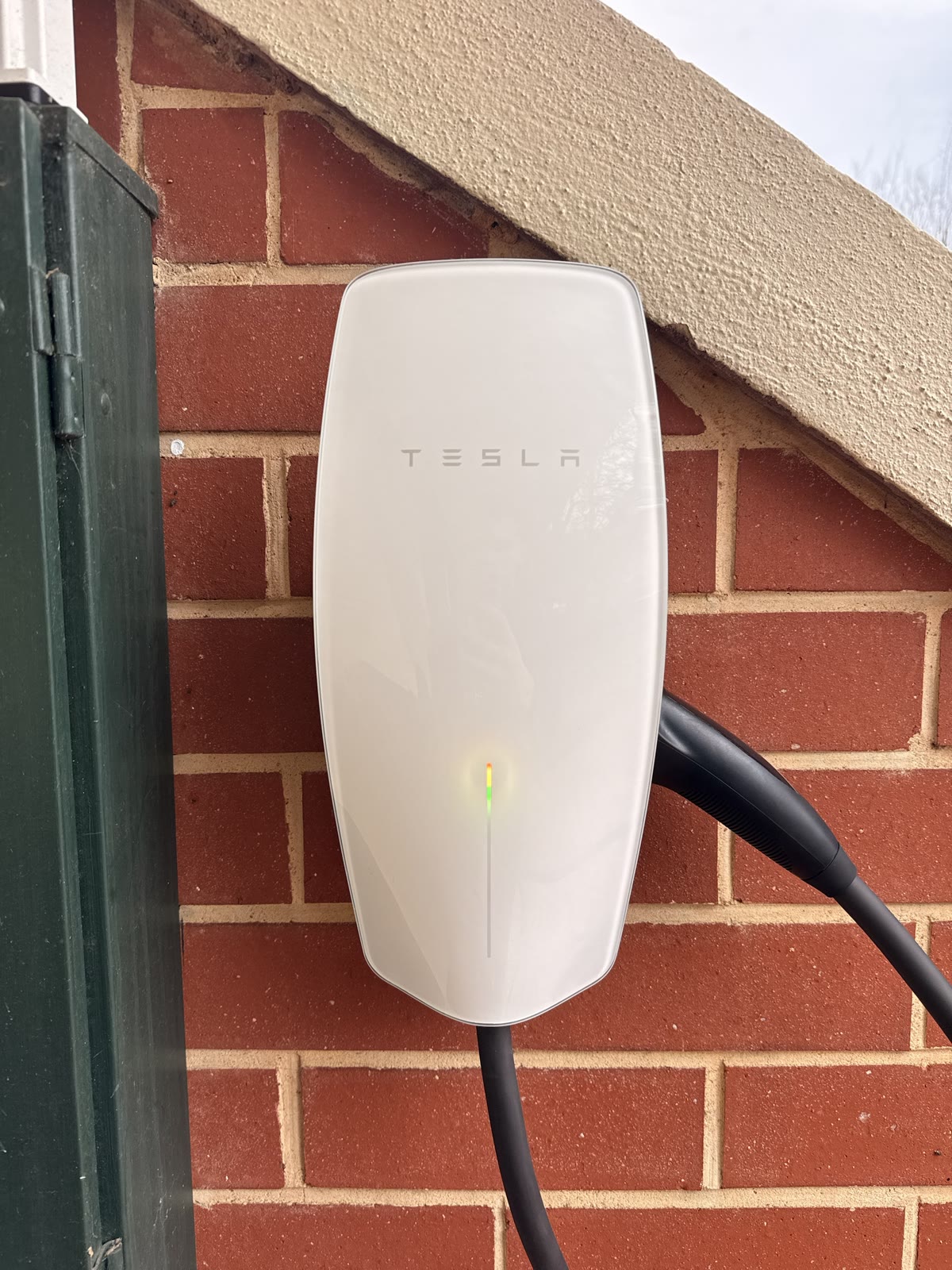 Tesla Wall Connector EV charger installed on a brick wall in Adelaide