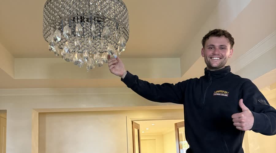 Marcus after installing a crystal chandelier in an Adelaide home