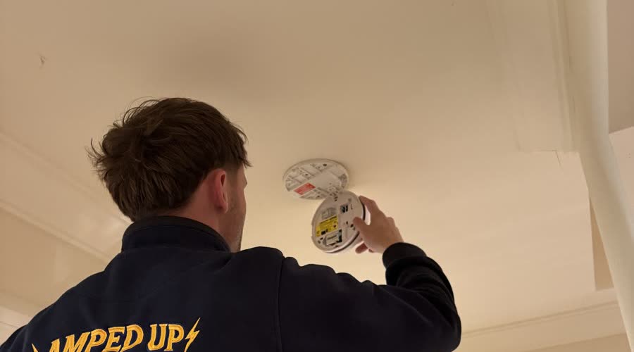 Marcus replacing a ceiling smoke alarm in an Adelaide home