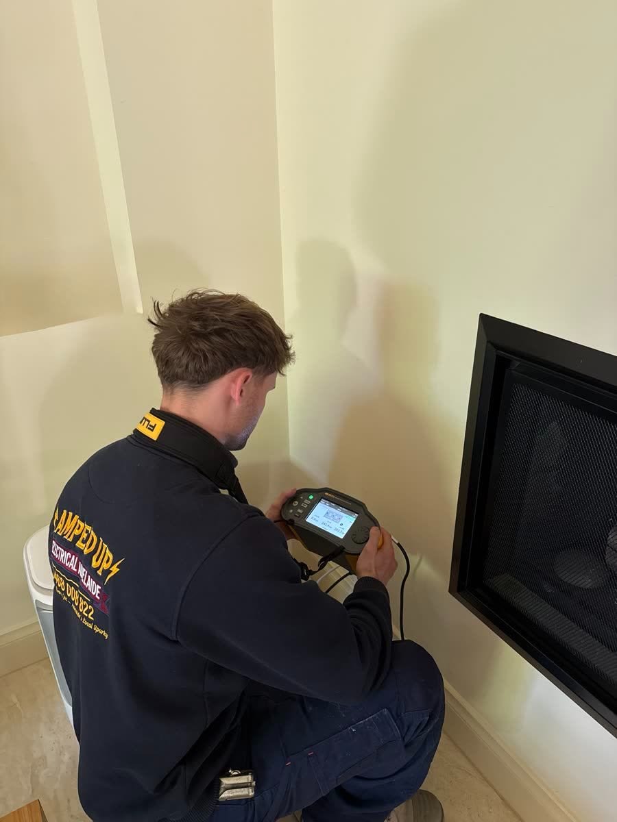 Marcus testing a circuit with a Fluke multifunction tester