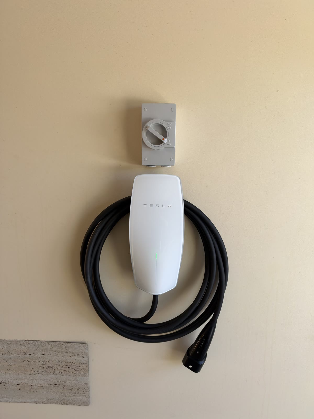Tesla Wall Connector installed in a Salisbury Heights garage with the isolator mounted above it