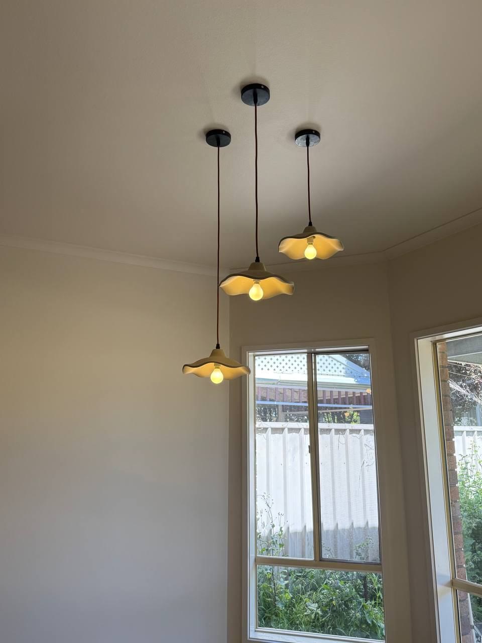 Three pendant lights hung over a bay window