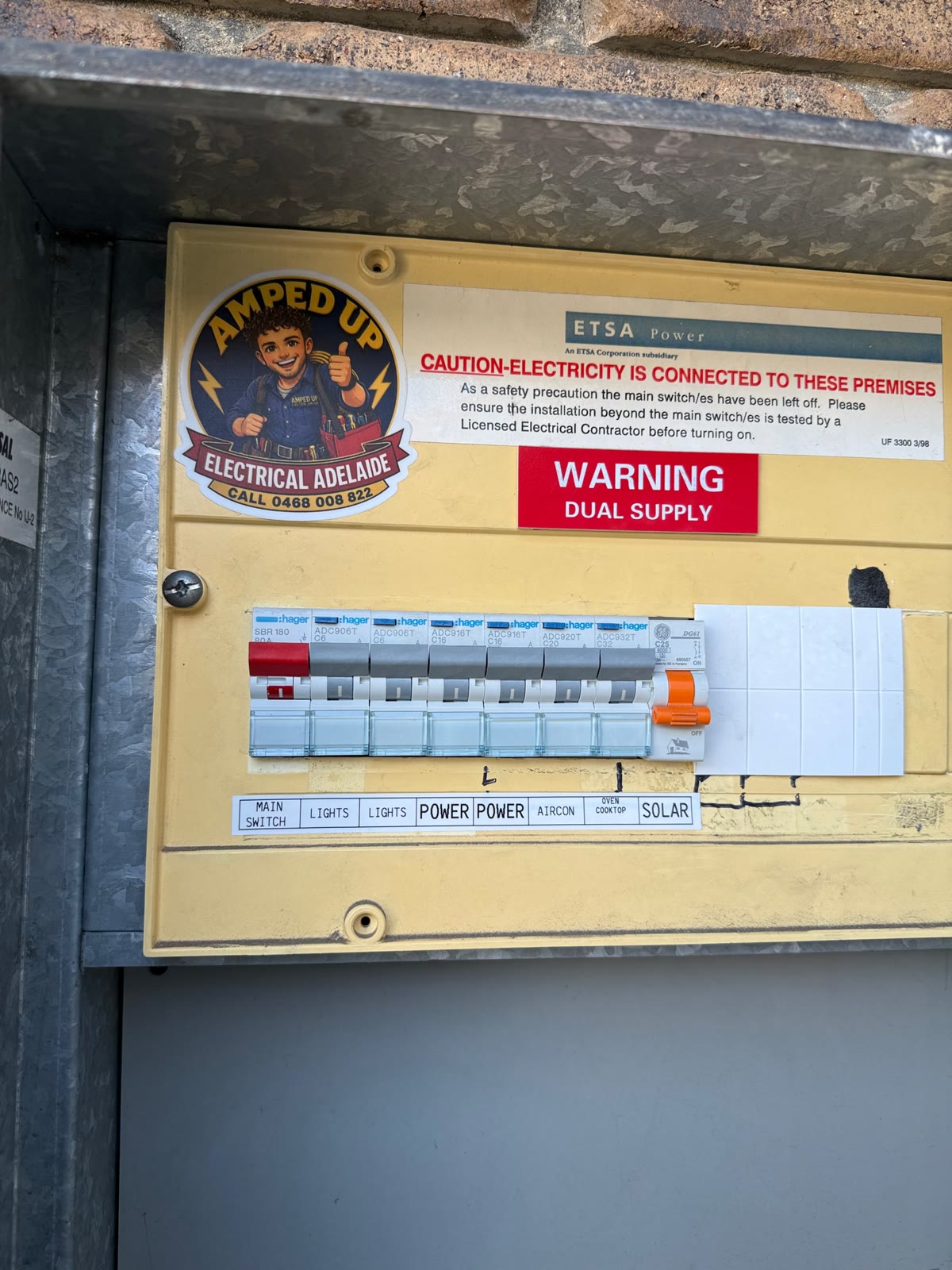 Windsor Gardens meter box with the new RCBOs labelled and the Amped Up sticker on the board